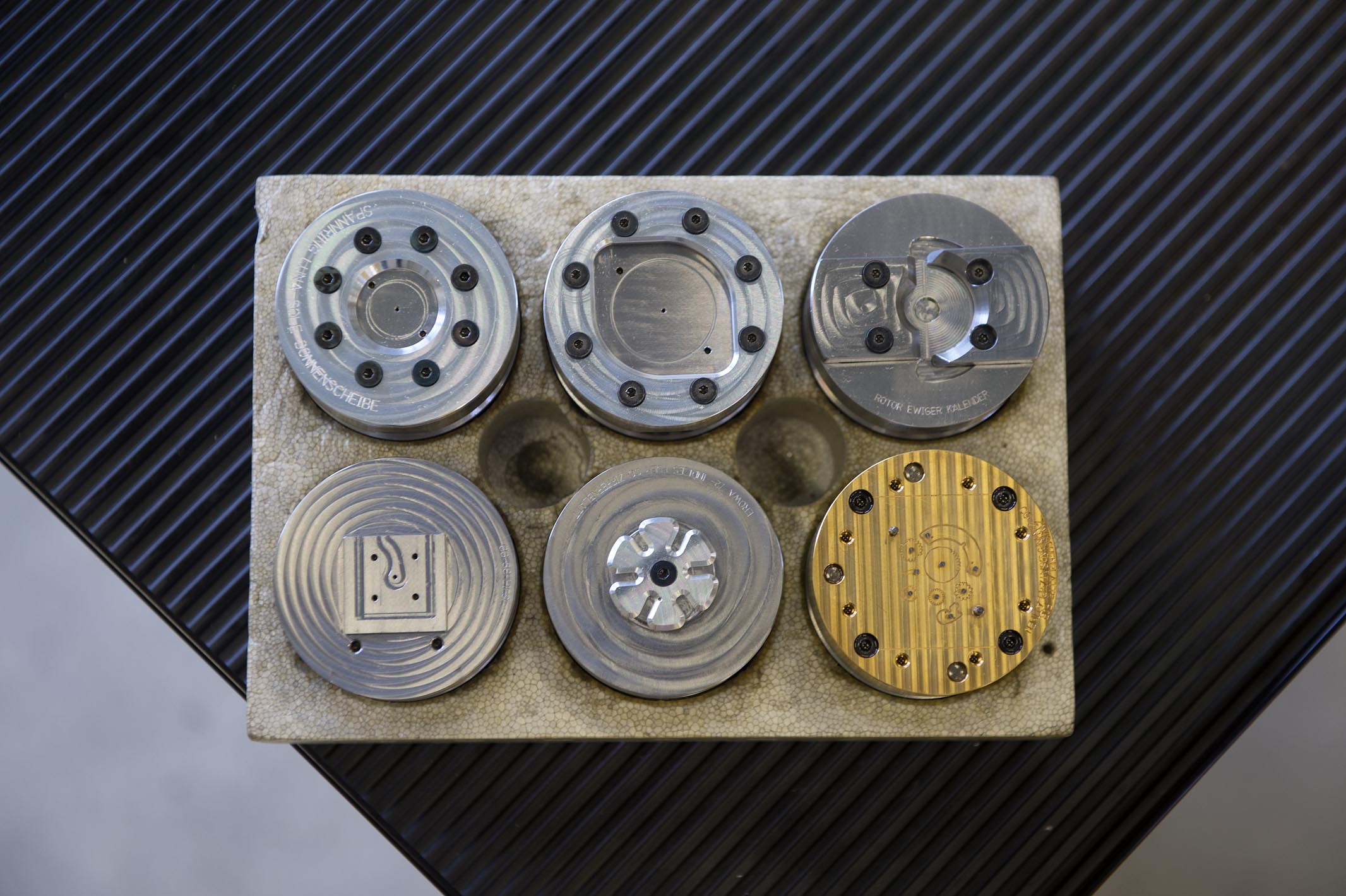 A few of the clamping devices that we created specifically to manufacture the parts of the perpetual calendar.