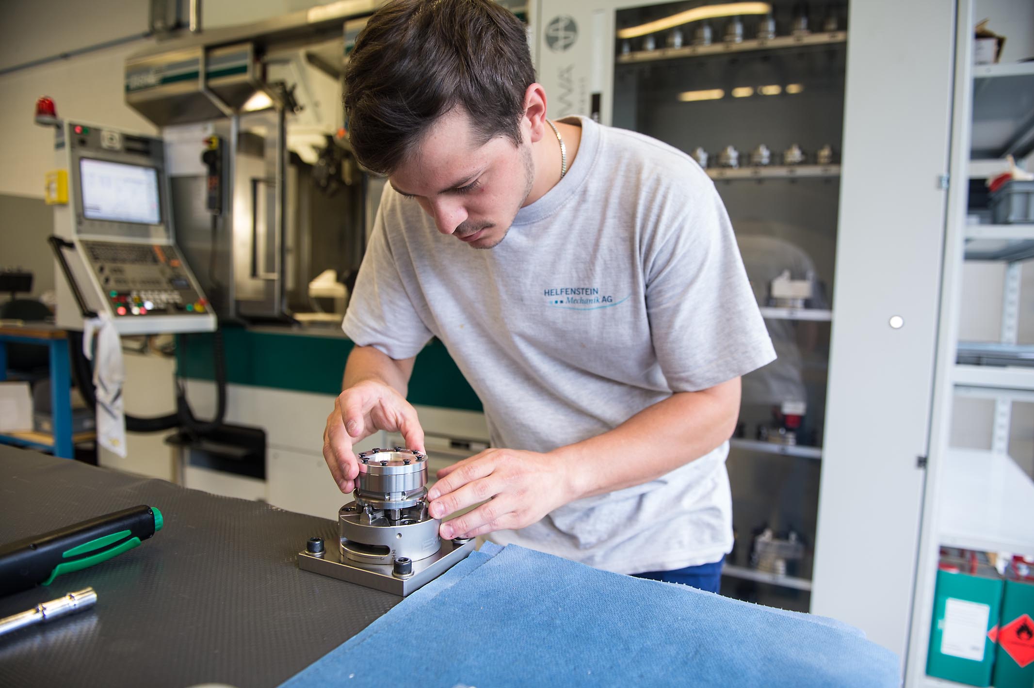 Daniel Matter is clamping the brass blank into the device.