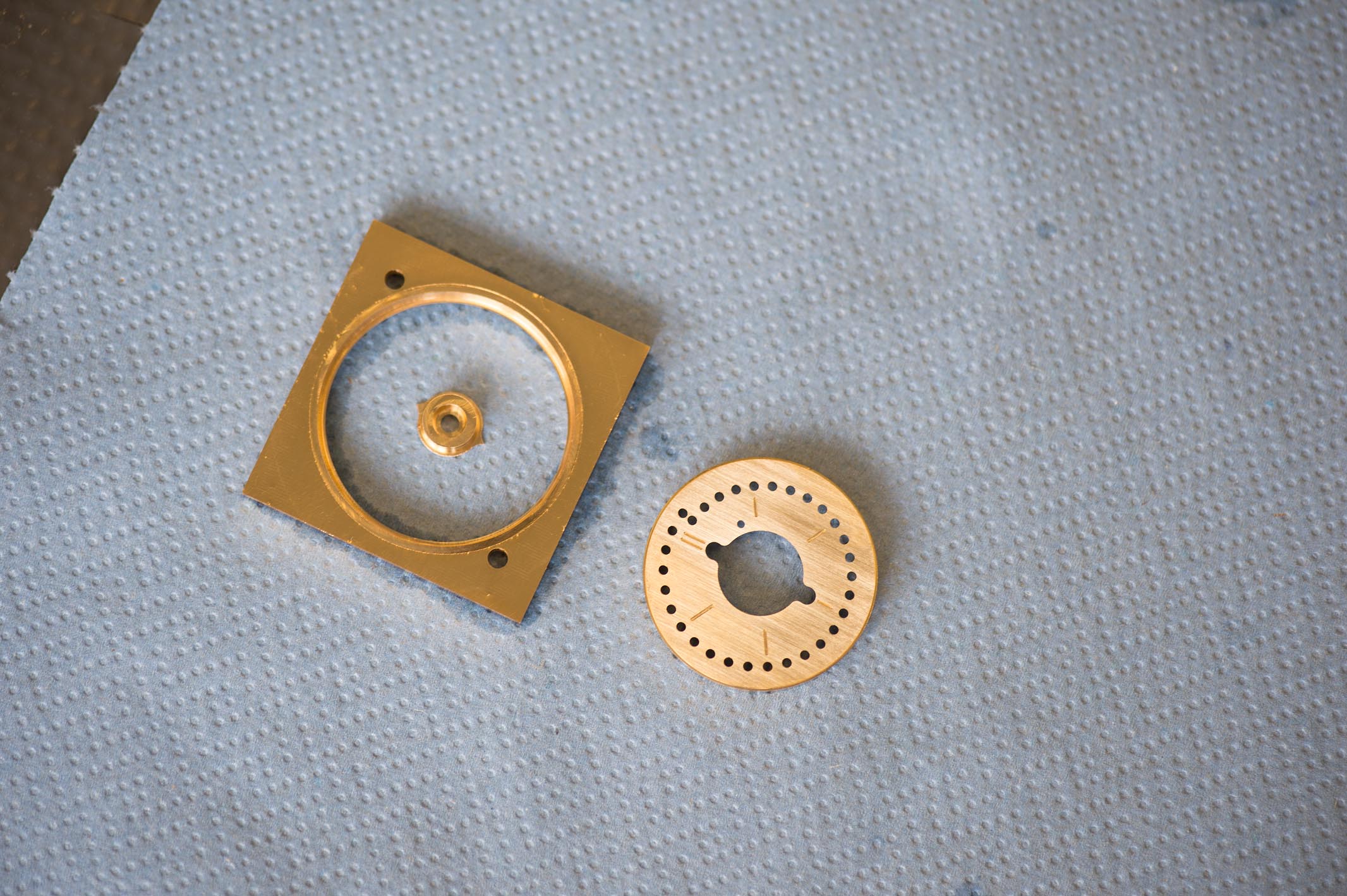 The finished dial and the spare material which will be recycled.