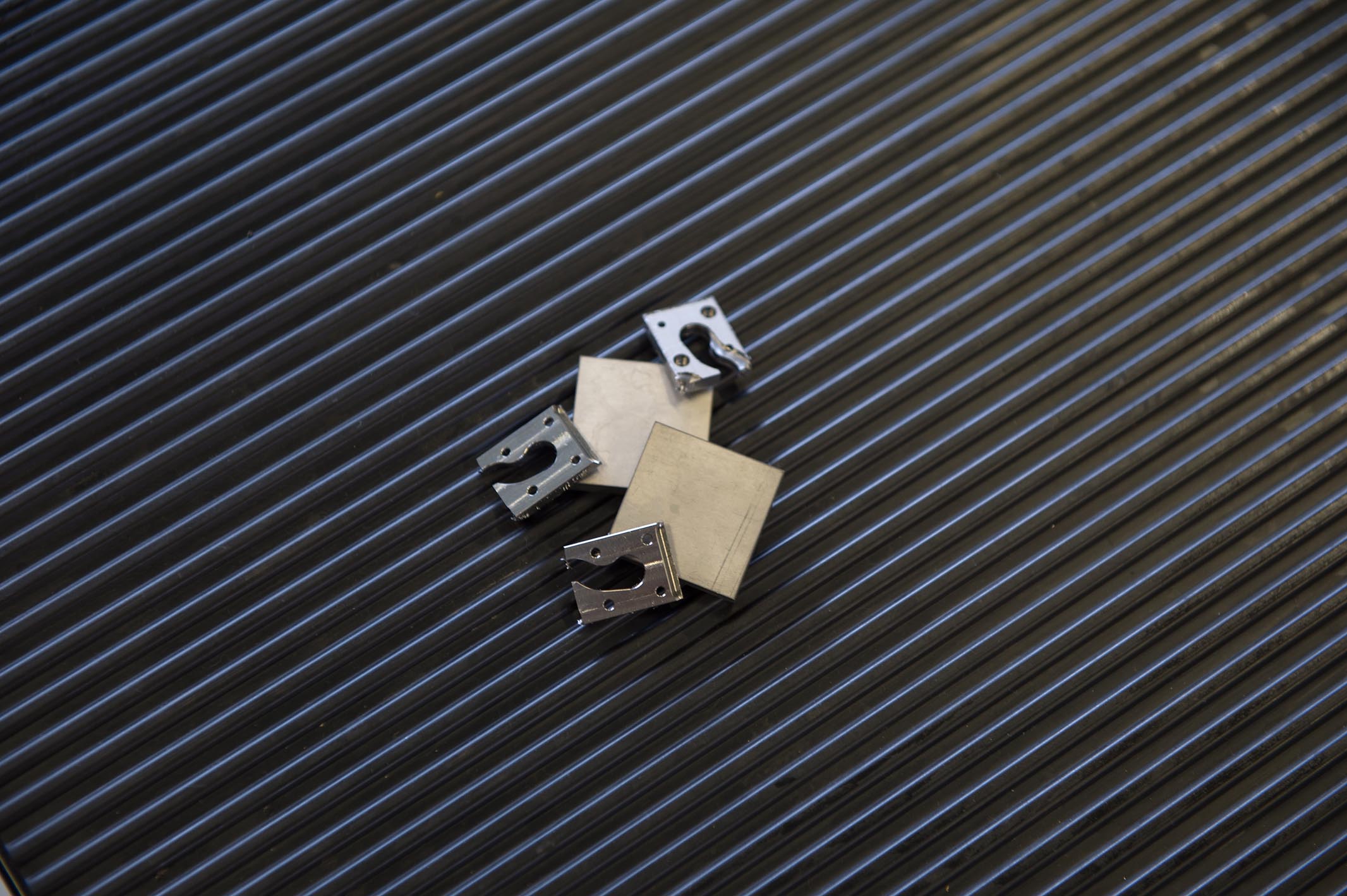 Titanium blanks and leftover material from the production of buckles.
