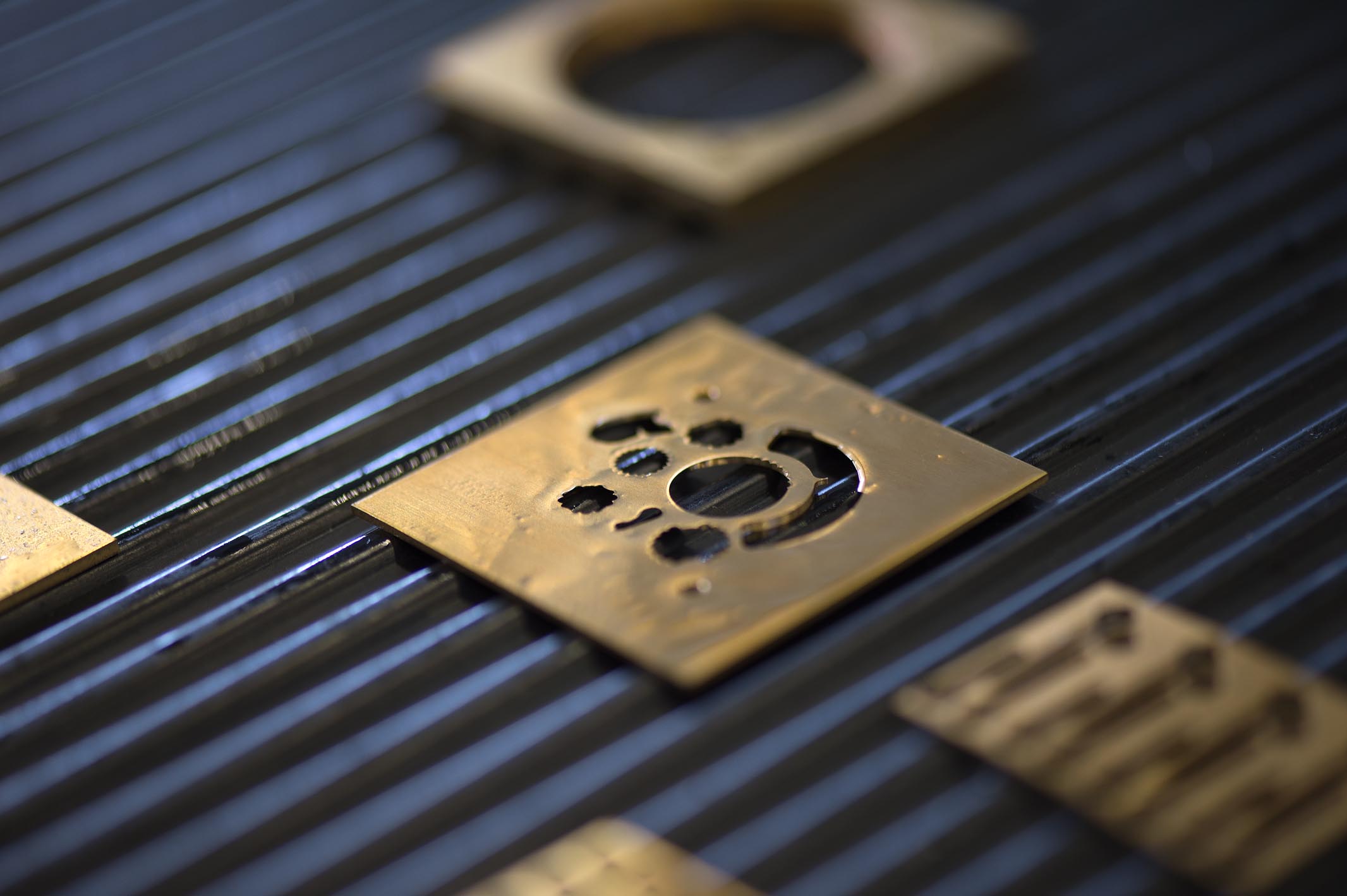 The brass blanks after we have milled out the functions of the perpetual calendar.