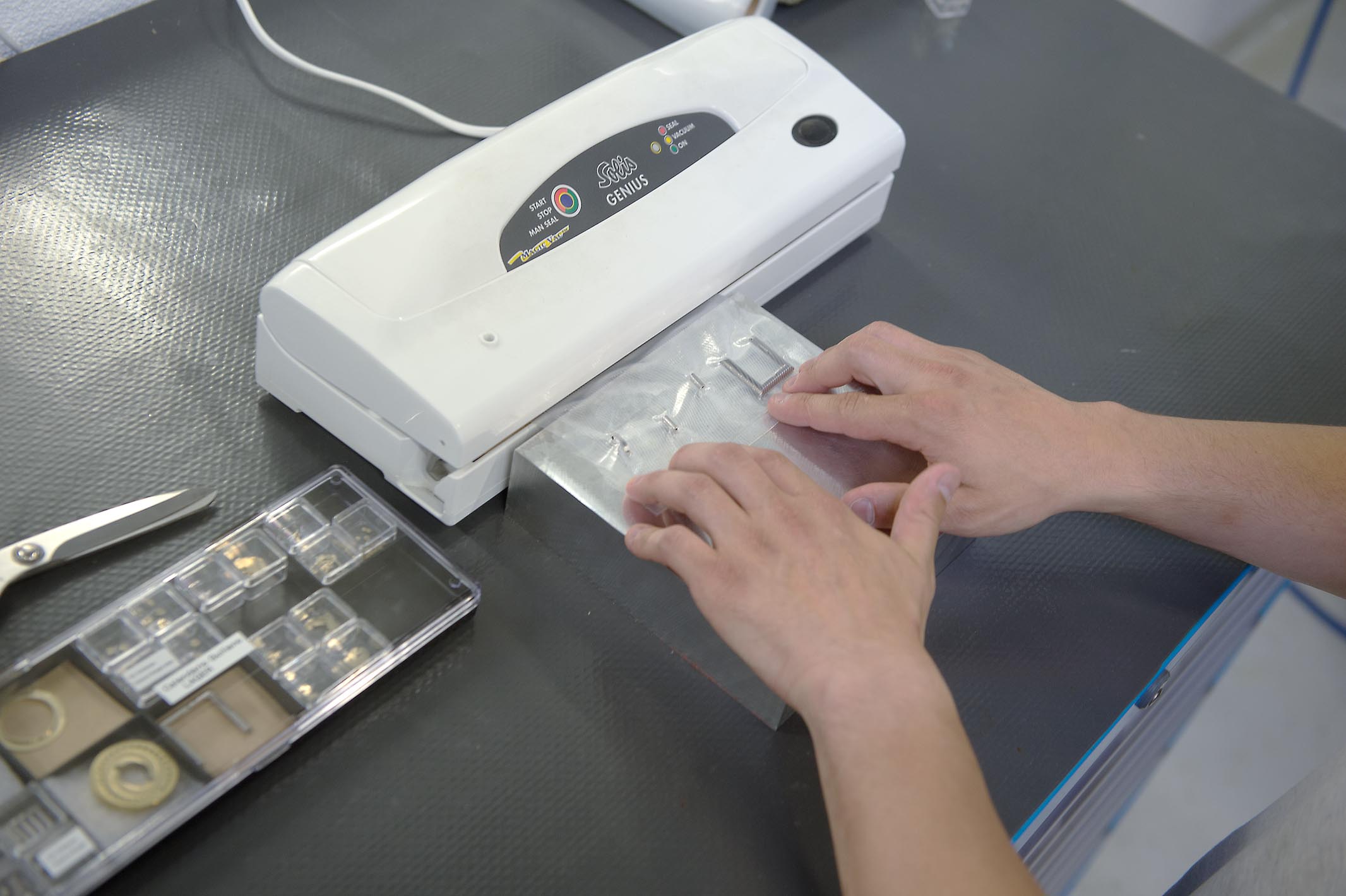 Daniel Matter is vacuum sealing a finished buckle.